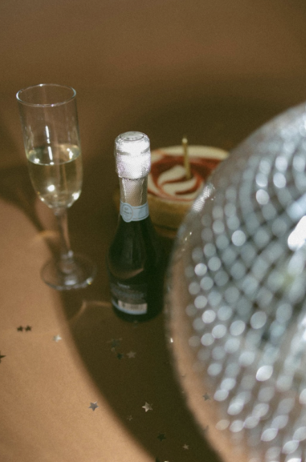 4th of July real estate marketing celebration setup with champagne, dessert, and disco ball decor